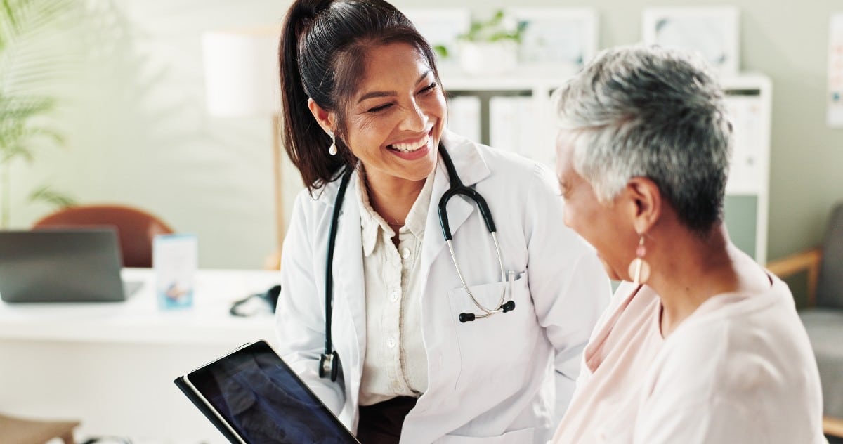 A woman consulting with a smiling doctor